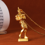 Gold-colored trophy figure on a chain against a brown background